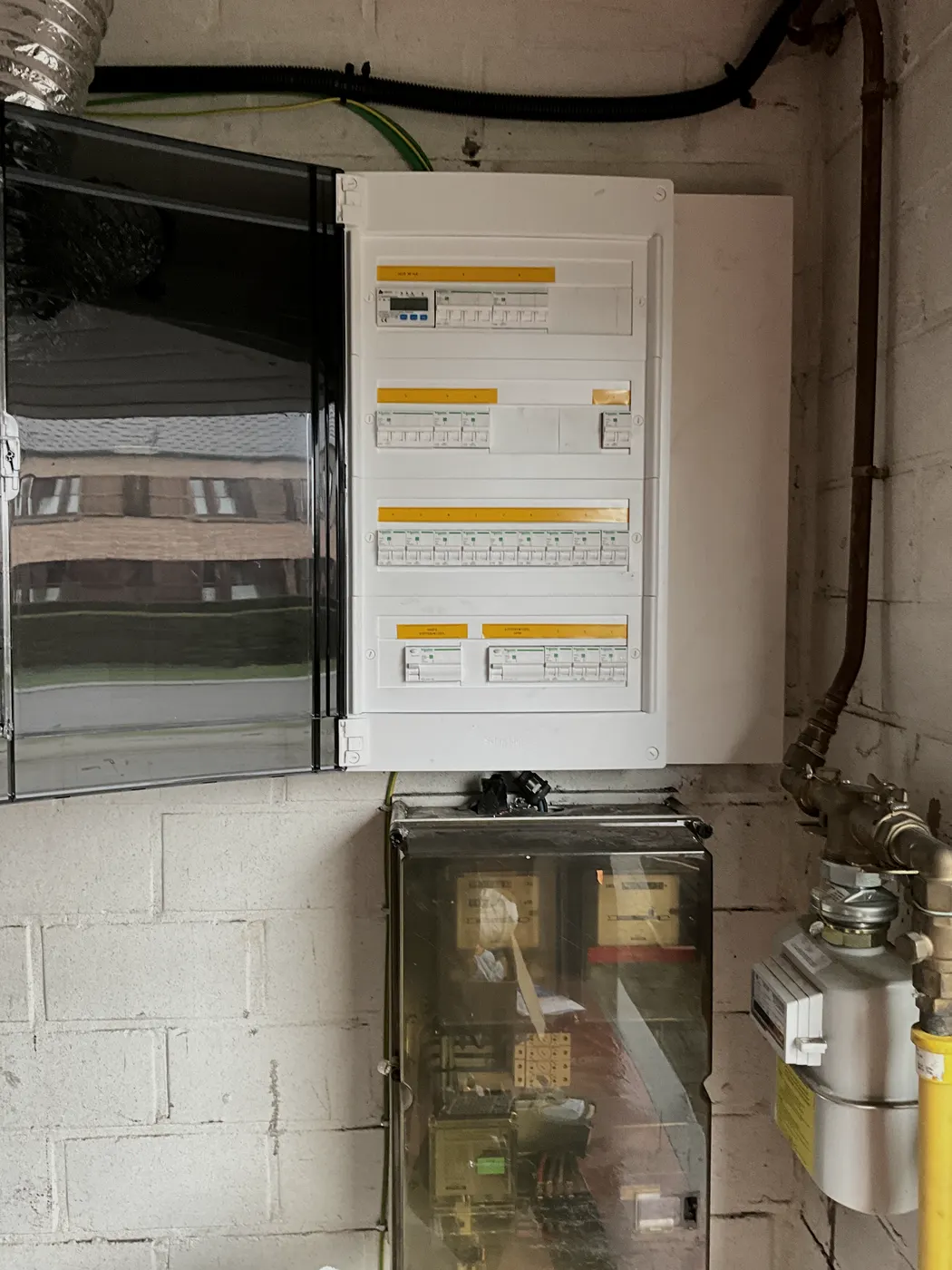 nieuwe witte verdeelkast naast gasmeter in garage, geplaatst door Wattra